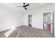 Bright bedroom boasts neutral carpet, ceiling fan, and a walk-in closet at 3076 Kelly St, Scottdale, GA 30079