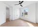 Minimalist bedroom with neutral walls, hardwood floors, a fan, and natural light at 3076 Kelly St, Scottdale, GA 30079