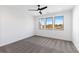 Minimalist bedroom with three windows allowing natural light and stylish ceiling fan at 3076 Kelly St, Scottdale, GA 30079