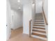 Bright entry hallway featuring wood floors and staircase with contrasting modern design at 3076 Kelly St, Scottdale, GA 30079