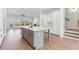 Modern kitchen island with bar seating, stone countertops, and stainless steel appliances at 3076 Kelly St, Scottdale, GA 30079
