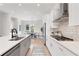 Contemporary kitchen with a center island, stainless steel appliances, and access to the outdoor dining area at 3076 Kelly St, Scottdale, GA 30079