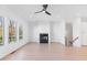 Spacious living room featuring a modern fireplace, hardwood floors, and bright natural light at 3076 Kelly St, Scottdale, GA 30079