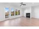 Open concept living space featuring hardwood floors, a modern fireplace, and access to an outdoor balcony at 3076 Kelly St, Scottdale, GA 30079