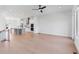 Bright, open concept living area showcasing a modern kitchen with stainless steel appliances and hardwood floors at 3076 Kelly St, Scottdale, GA 30079