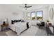 Bright main bedroom with three large windows, modern decor, and a stylish seating area at 3076 Kelly St, Scottdale, GA 30079