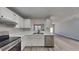 White kitchen with stainless steel appliances and view into the living room at 3677 Platina Park Ct, Decatur, GA 30034