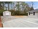 View of the home with a large patio, graveled area and storage building at 2771 Ridge Park Dr, Tucker, GA 30084