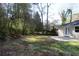 Charming home featuring an outdoor patio with a large grassy backyard surrounded by mature trees at 2771 Ridge Park Dr, Tucker, GA 30084