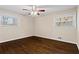 Bedroom with hardwood floors, ceiling fan, and two windows providing ample natural light at 2771 Ridge Park Dr, Tucker, GA 30084