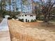 A nice view of the home featuring a long driveway, well-maintained yard, and a detached storage shed at 2771 Ridge Park Dr, Tucker, GA 30084
