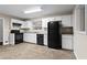 A well-maintained kitchen features white cabinets and black appliances at 2771 Ridge Park Dr, Tucker, GA 30084
