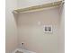 Convenient laundry hookups with upper storage shelves for organizing supplies at 2771 Ridge Park Dr, Tucker, GA 30084