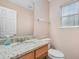 Small bathroom with granite countertop and wood vanity at 6207 Willowbrook Dr, Riverdale, GA 30296