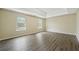 Spacious bedroom with hardwood floors and two windows at 6207 Willowbrook Dr, Riverdale, GA 30296