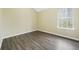 Bright bedroom with wood-look floors, large closet, and window at 6207 Willowbrook Dr, Riverdale, GA 30296