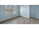 Bedroom with wood-look floors and an arched window at 6207 Willowbrook Dr, Riverdale, GA 30296