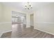 Open dining room with view into living room and hardwood floors at 6207 Willowbrook Dr, Riverdale, GA 30296
