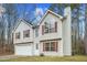 Two-story house with attached garage and red shutters at 6207 Willowbrook Dr, Riverdale, GA 30296