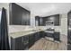 Modern kitchen with dark cabinets, granite counters, and stainless steel appliances at 6207 Willowbrook Dr, Riverdale, GA 30296