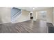 Open living room with gray vinyl flooring and neutral walls at 6207 Willowbrook Dr, Riverdale, GA 30296