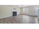 Living room with fireplace, vinyl flooring, and neutral walls at 6207 Willowbrook Dr, Riverdale, GA 30296