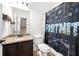 Bathroom with granite countertop, dark brown vanity, and Fortnite themed shower curtain at 4302 Maclaren Ct, Powder Springs, GA 30127