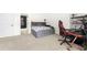 Spacious bedroom with built-in shelving, gaming setup, and access to bathroom at 4302 Maclaren Ct, Powder Springs, GA 30127