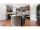 Large kitchen island with granite countertop and dark cabinets at 4302 Maclaren Ct, Powder Springs, GA 30127