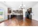 Open concept kitchen with dark cabinets and hardwood floors at 4302 Maclaren Ct, Powder Springs, GA 30127