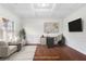 Virtually staged living room with hardwood floors and white walls at 4302 Maclaren Ct, Powder Springs, GA 30127