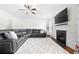 Open living room featuring a sectional sofa and fireplace at 4302 Maclaren Ct, Powder Springs, GA 30127