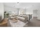 Virtually staged loft with sectional sofa and coffee table at 4302 Maclaren Ct, Powder Springs, GA 30127