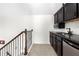 Basement wet bar with granite countertop and dark brown cabinetry at 4302 Maclaren Ct, Powder Springs, GA 30127
