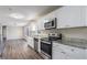 Renovated kitchen with granite countertops and stainless steel appliances at 475 Shannon Way, Lawrenceville, GA 30044