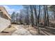 House side yard with a long driveway and mature trees at 475 Shannon Way, Lawrenceville, GA 30044