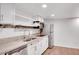 Small basement kitchen with white cabinets, granite counters, and stainless steel appliances at 2530 Ashbourne Dr, Lawrenceville, GA 30043
