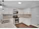 Bright kitchen features granite countertops, stainless steel appliances, and white cabinets at 2530 Ashbourne Dr, Lawrenceville, GA 30043