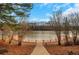 Steps lead down to a peaceful lakefront deck at 2530 Ashbourne Dr, Lawrenceville, GA 30043