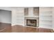 Living room with stone fireplace and built-in shelving at 2530 Ashbourne Dr, Lawrenceville, GA 30043