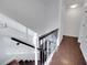 Dark wood staircase with metal railing, leading to upper level at 2530 Ashbourne Dr, Lawrenceville, GA 30043