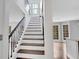 Elegant staircase with dark wood steps and black metal railing at 2530 Ashbourne Dr, Lawrenceville, GA 30043