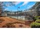 Tennis courts with pavilion and surrounding nature at 2530 Ashbourne Dr, Lawrenceville, GA 30043