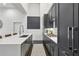 Modern kitchen featuring stainless steel appliances, gray cabinets, a white countertop, and a stylish patterned rug at 1200 Ponce De Leon Ne Ave # A1, Atlanta, GA 30306