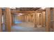 Large, unfinished basement featuring exposed beams and framed walls, offering expansion potential at 4525 Aiden Way, Cumming, GA 30041