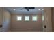Bedroom featuring neutral paint, carpet, ceiling fan, three windows and bright light at 4525 Aiden Way, Cumming, GA 30041
