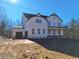 New two-story home showcasing white siding, a charming front porch, and a convenient attached two-car garage at 4525 Aiden Way, Cumming, GA 30041