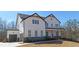 Charming two-story home with white siding, a covered porch, and an attached two-car garage at 4525 Aiden Way, Cumming, GA 30041