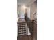 Hallway featuring hardwood floors, neutral paint, stairs and an open railing at 4525 Aiden Way, Cumming, GA 30041
