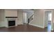 A spacious living room featuring a fireplace and built-ins, leading to other areas of the home at 4525 Aiden Way, Cumming, GA 30041